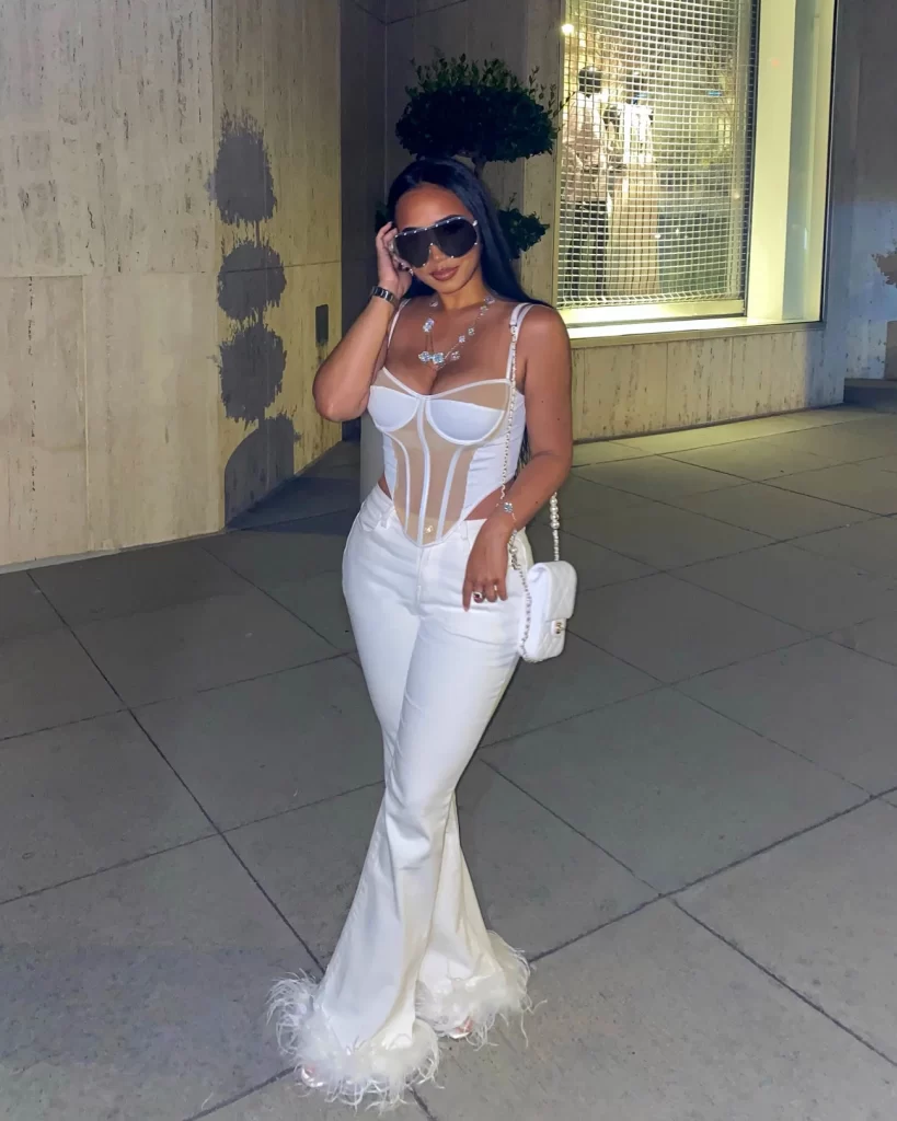 JC in all white sexy Jet set babe look